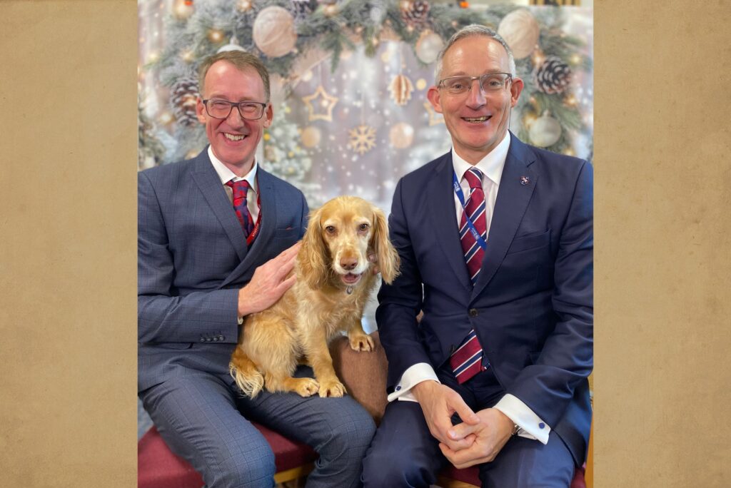 Cory Lowde, Ambassador of Akademis Boarding Schools Consulting, together with Chris Hutchinson, Headmaster of Royal Russell School, and the school dog Scrumpy.